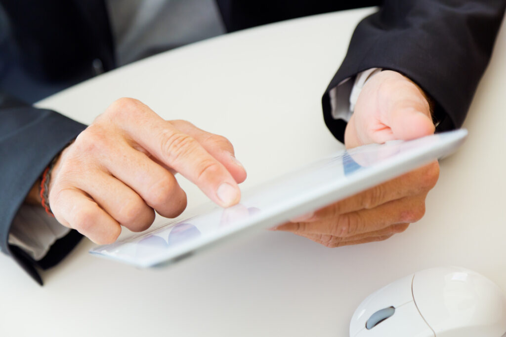man-s-hands-using-tablet